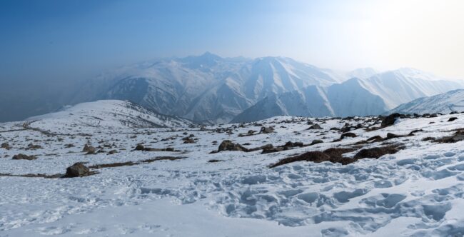 a snow covered mountain with a sky background