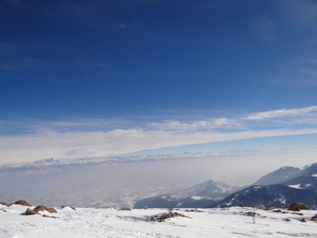 a person standing on top of a snow covered slope